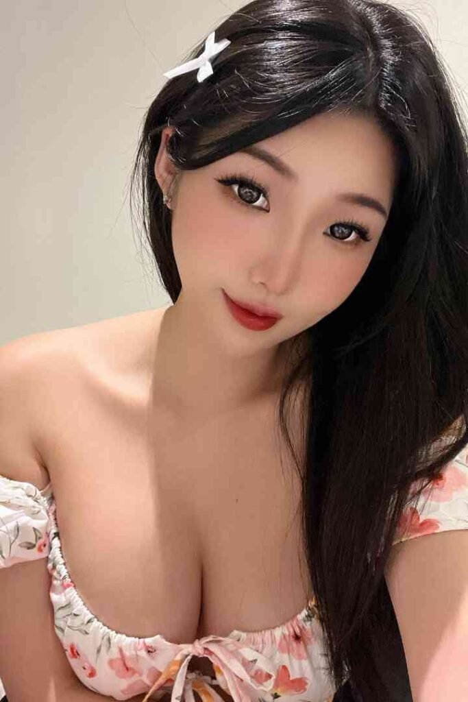 Beautiful Asian woman with floral top and hair clip.
