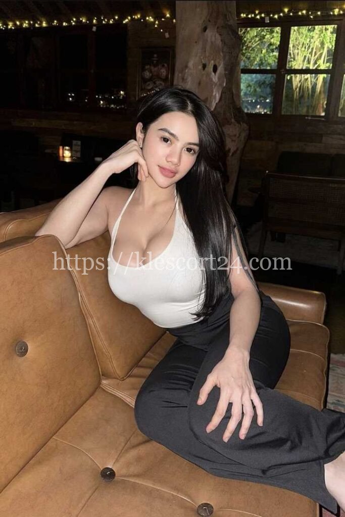 Sultry woman in white top and black pants. Malay Outcall Services available.