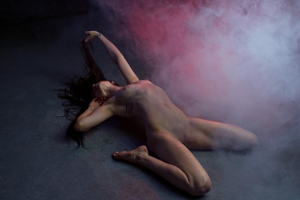 Chinese girl in lingerie sitting on a bed. "Chinese Girls" text overlay. KL Escort