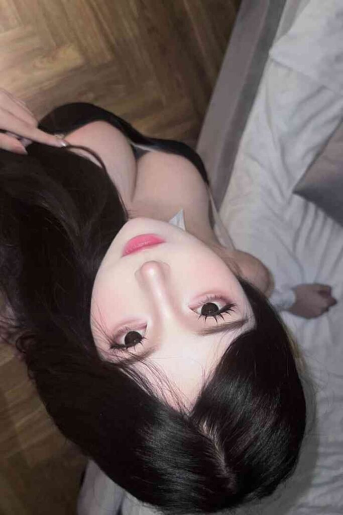 Exotic Vietnamese beauty Maycy, laying on a bed. KL escort.