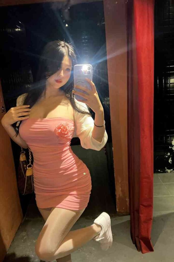 Nomin, exotic Mongolian beauty, poses in a pink dress for a mirror selfie in KL.