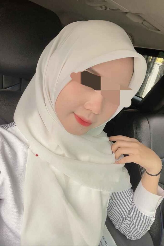 Eika, a 23yo Malay woman, wearing a hijab, promoting KL escort services